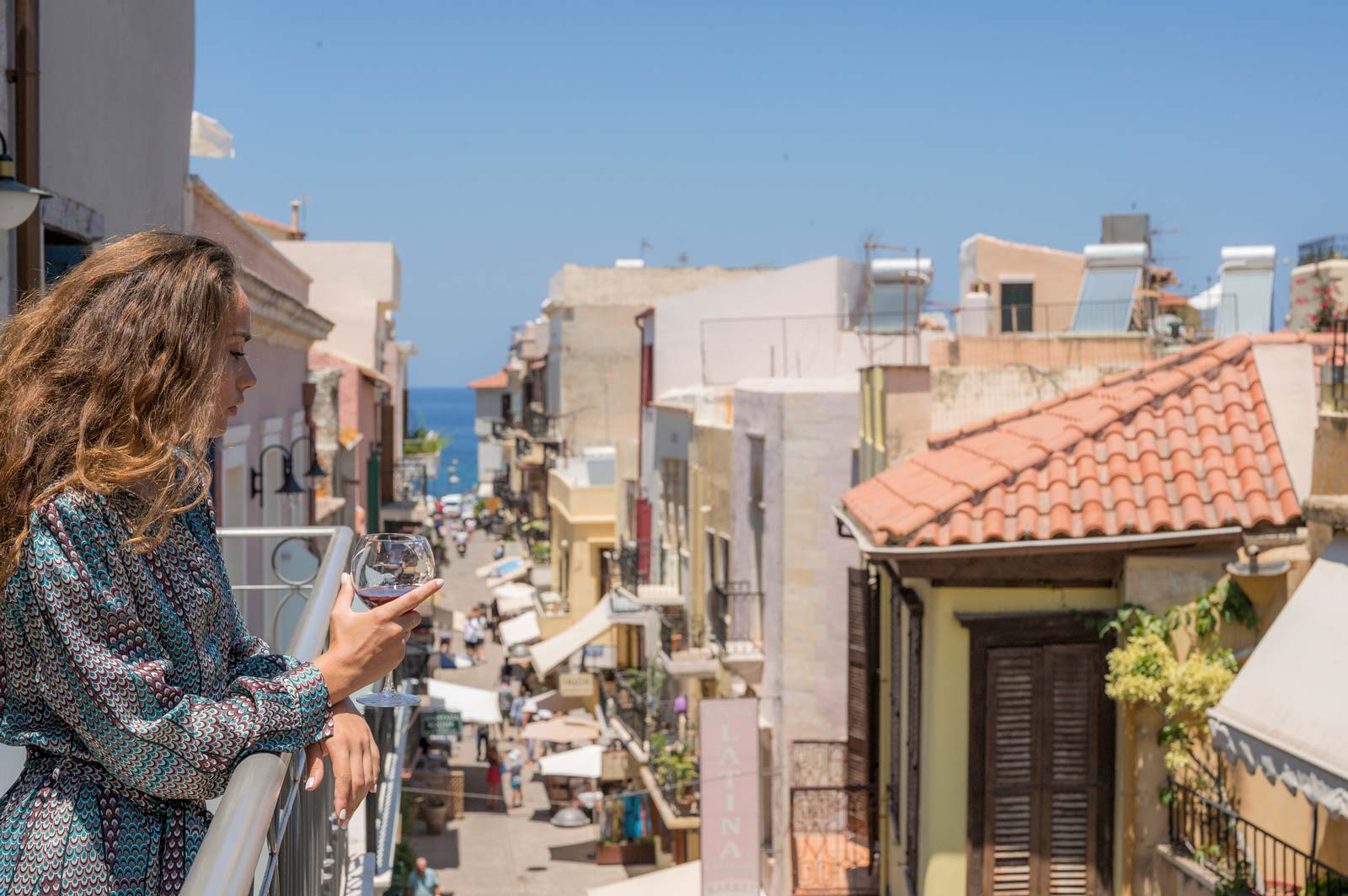 A woman staring the view from the balcony