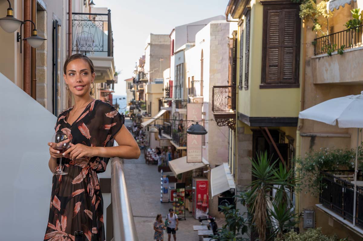 A woman staring the view from the balcony